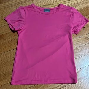 It’s a soft pink shirt that is made to be shorter.